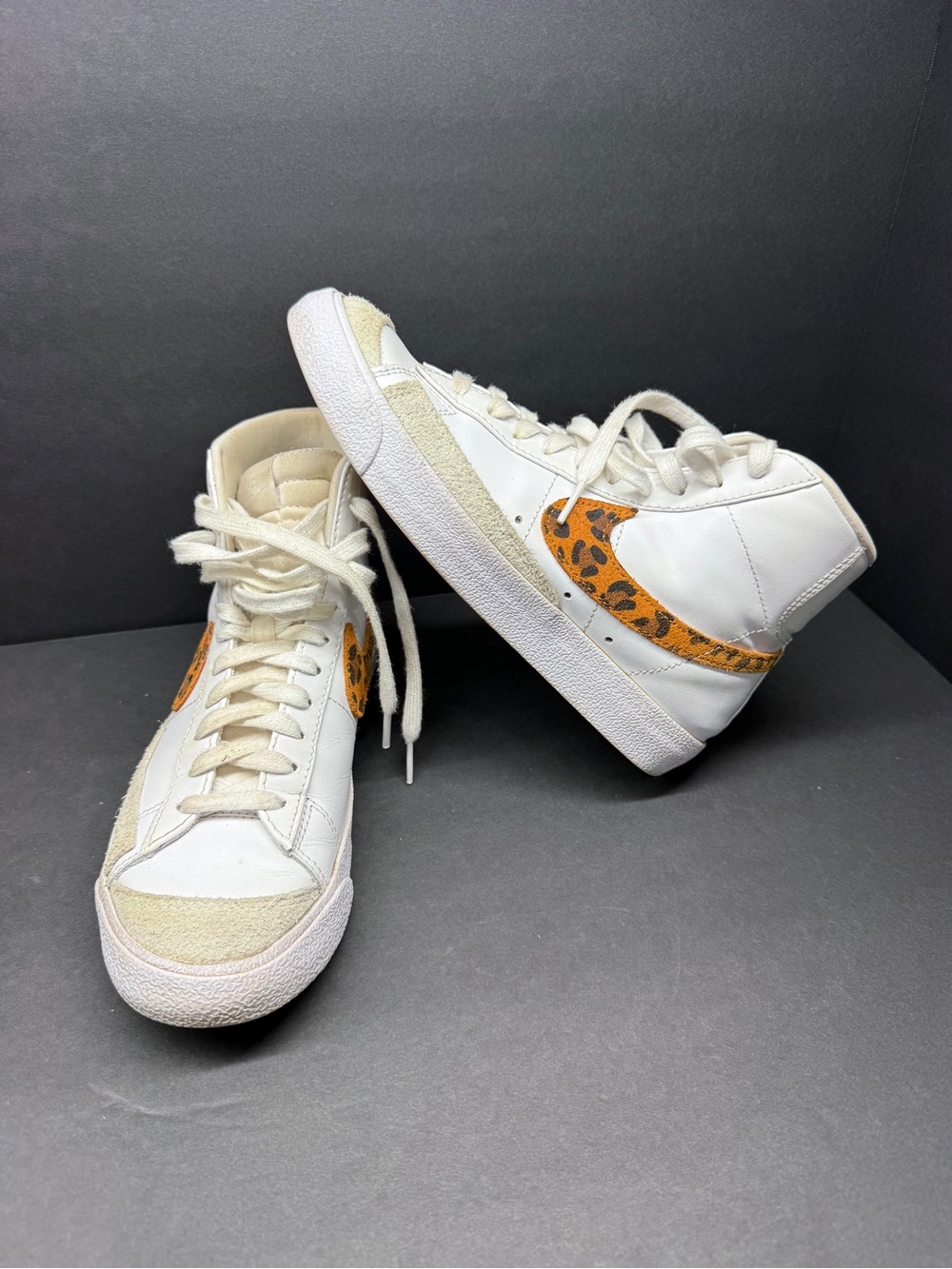 Nike Women's White High-Top Sneakers with Orange Leopard Swoosh